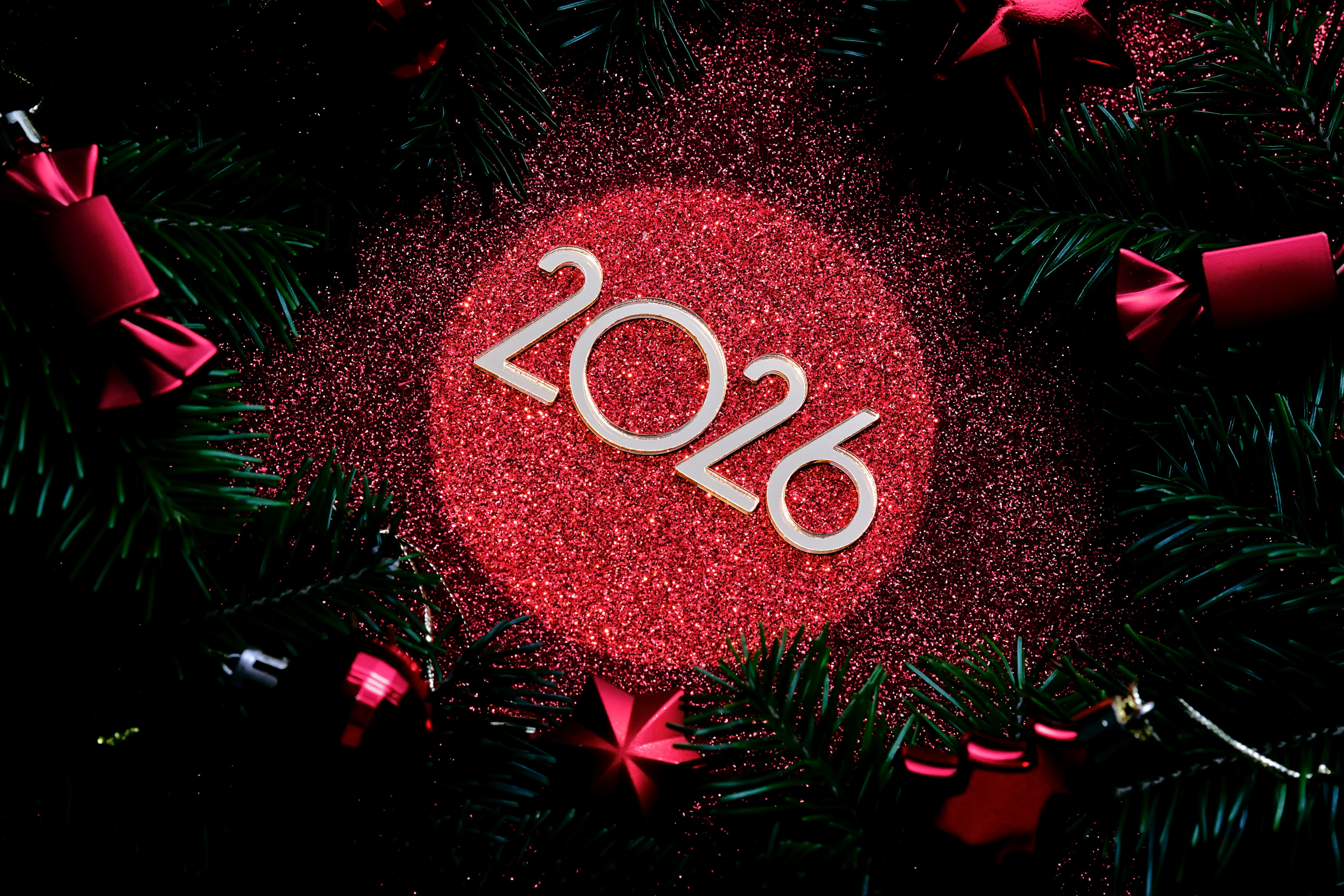 2026 numbers on black & red background with red bon bons